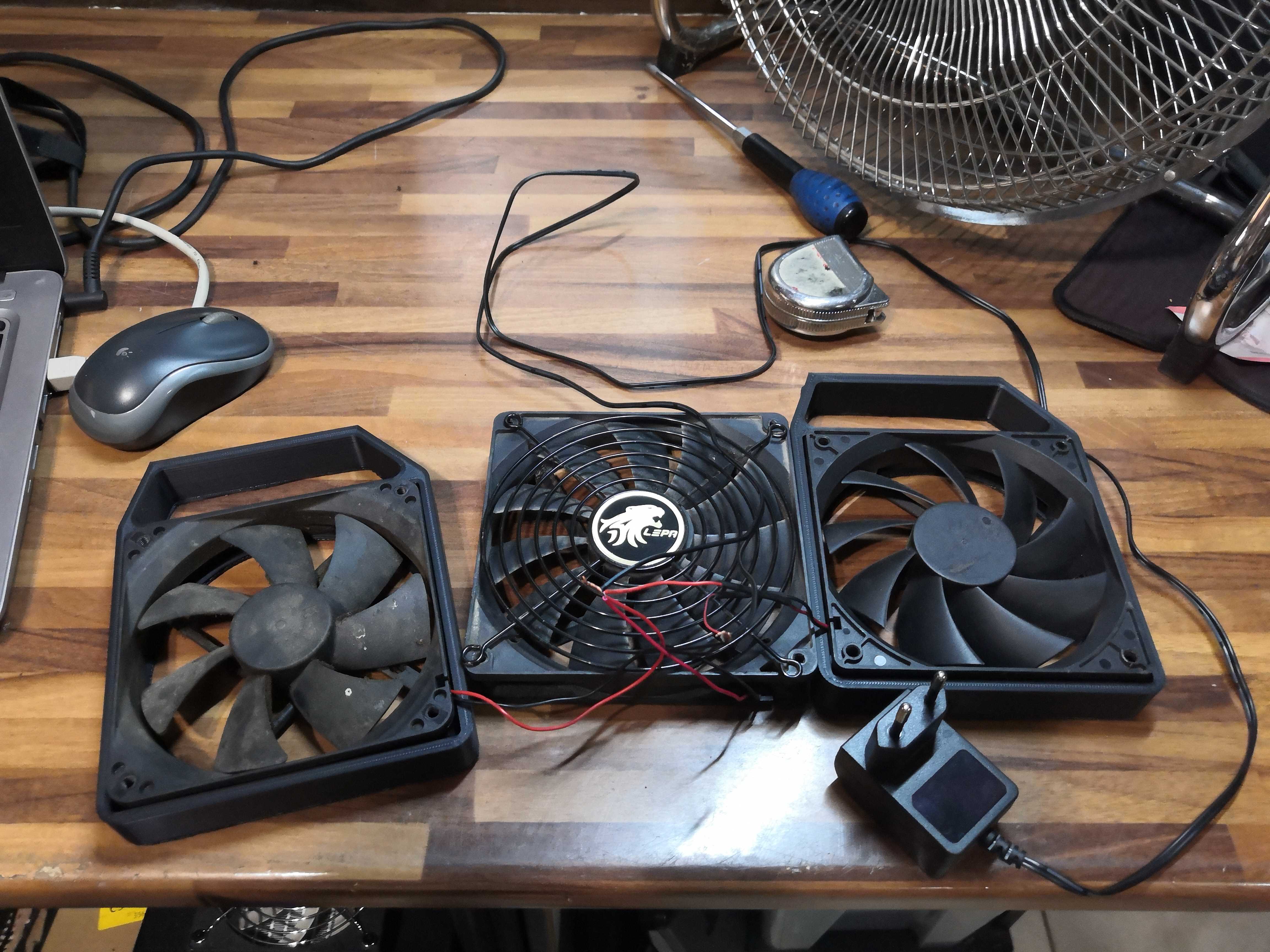 Starting inventory: three salvaged fans, a power supply, and a soldering iron