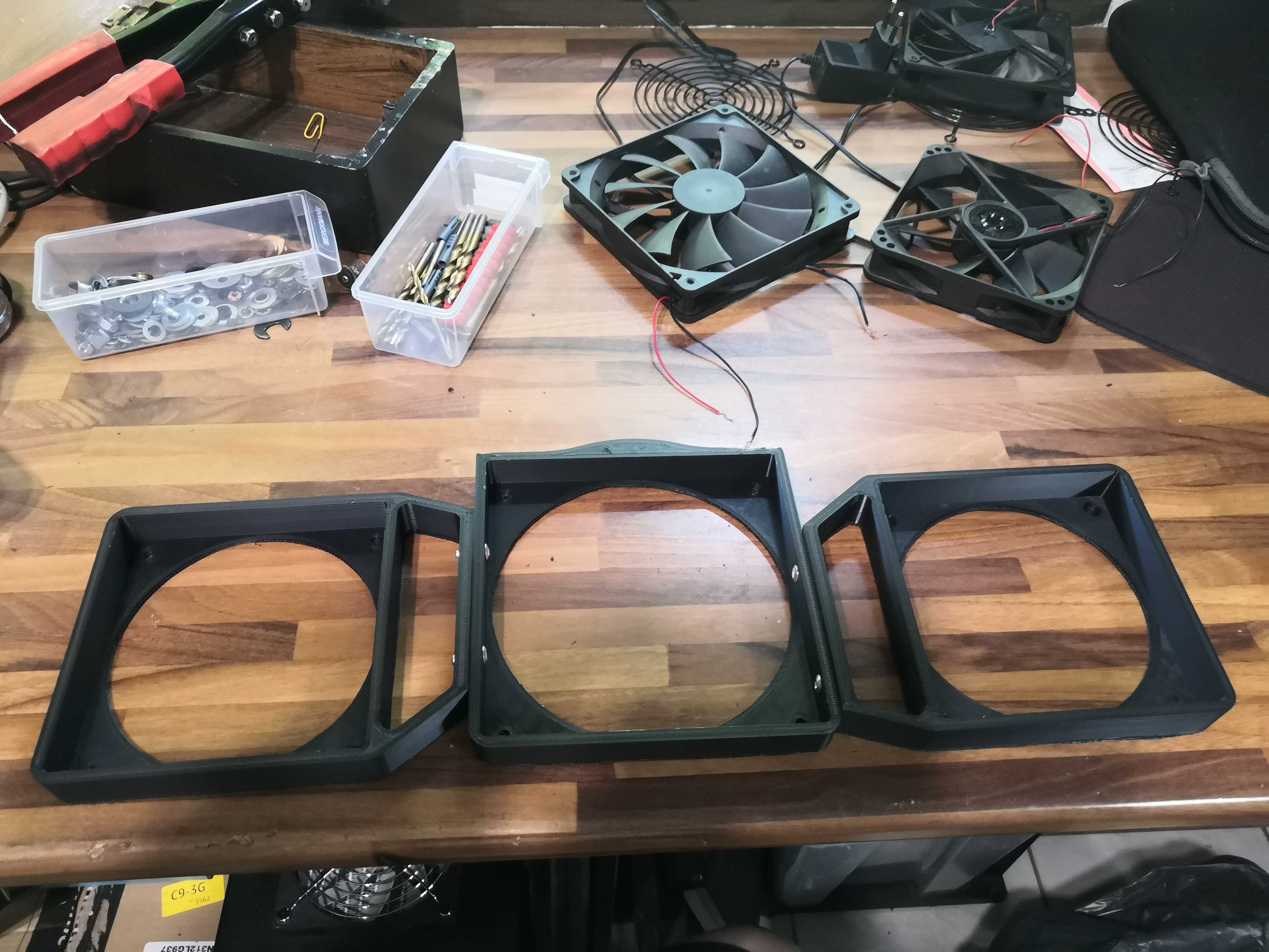 Brackets, fans, and boxes of screws ready for assembly