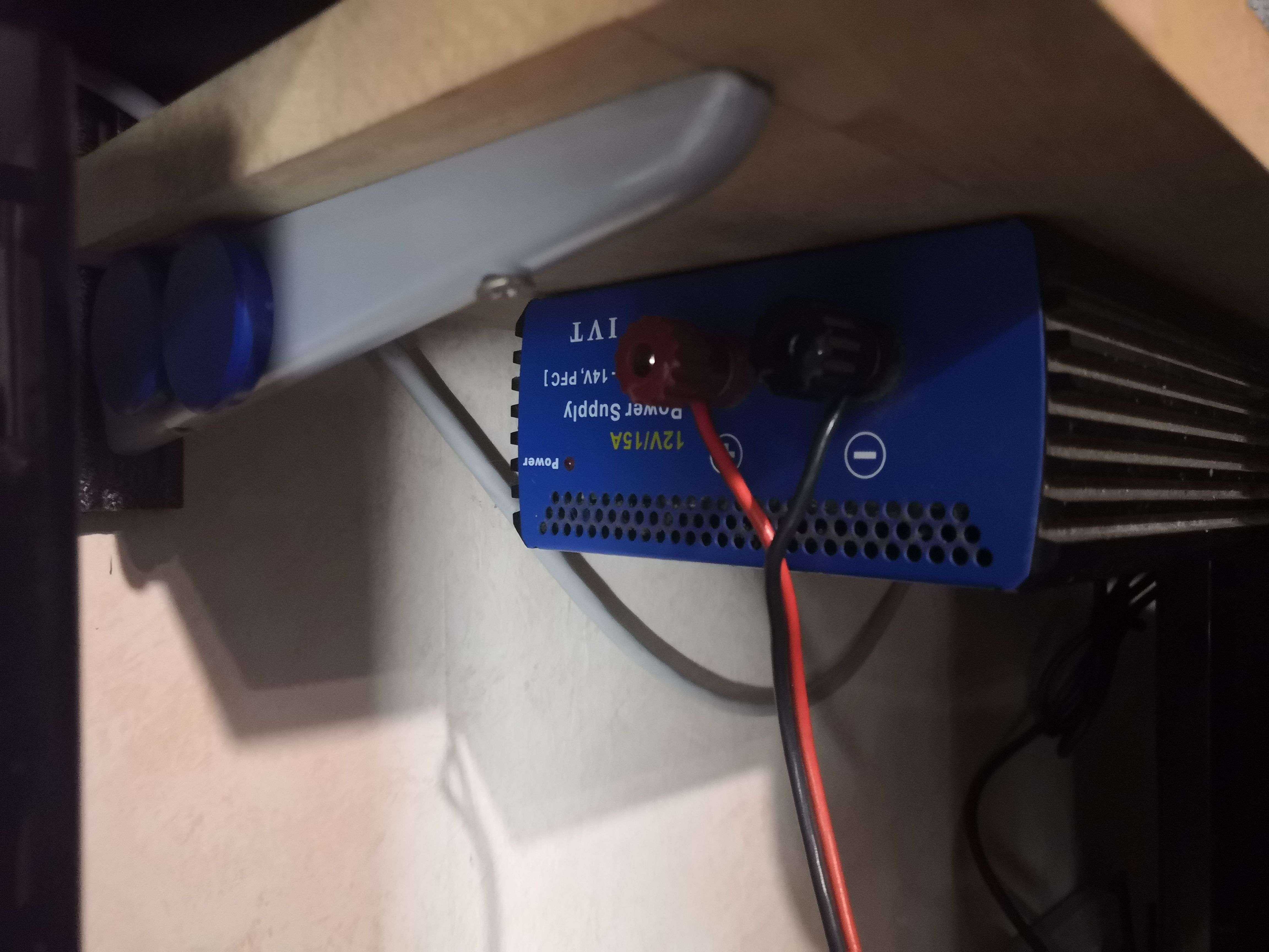 The blue IVT 12V/15A power supply under the workbench